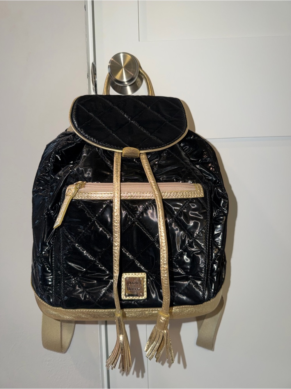 Dooney & Bourke Black Patent Quilted Backpack with Gold Accents